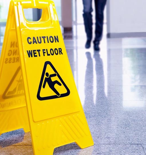 Caution wet floor yellow warning sign after laurence cleaning services have mopped floor