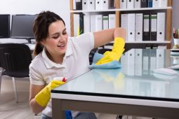 woman cleaning office desk