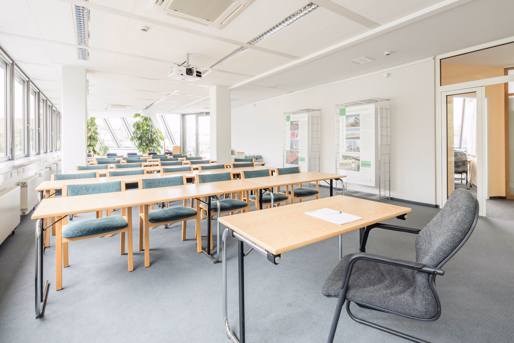 classroom with lots of light coming through windows and clean desks