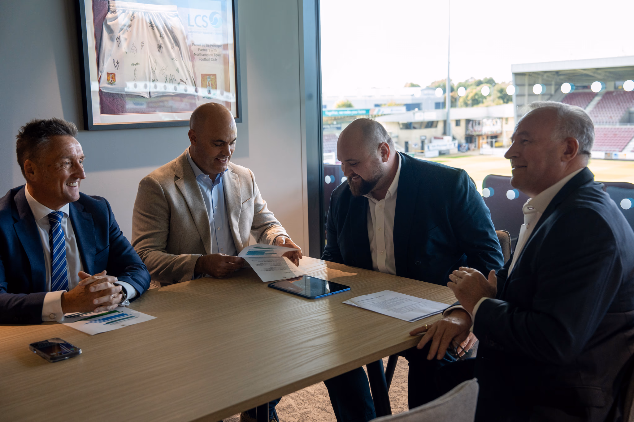 LCS senior management team having a meeting round a table at football ground