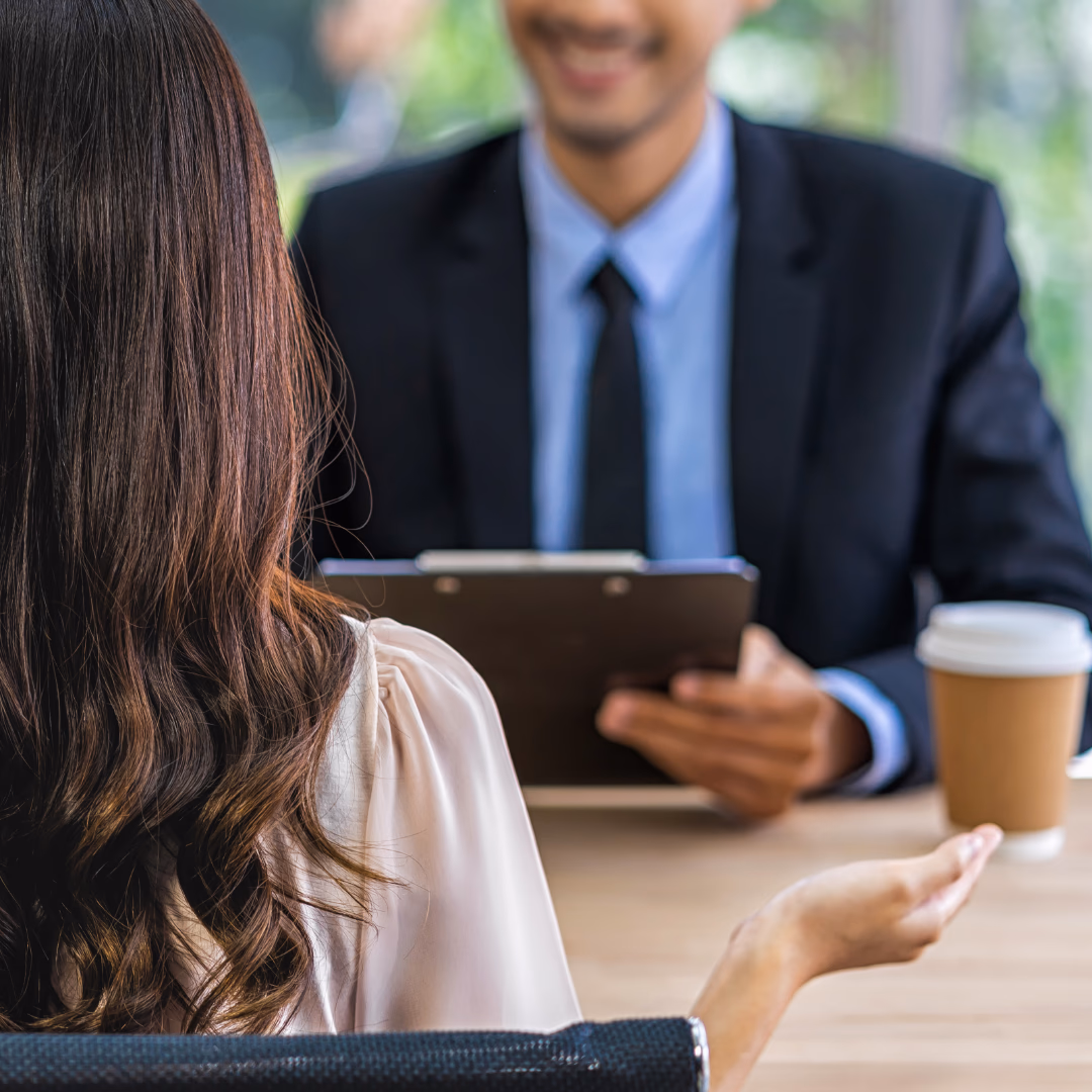male and female having a meeting with a coffee dressed smart