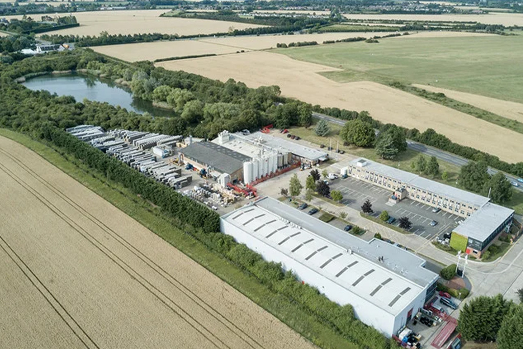 Birdseye view photo of an industrial building with lots of lorries parked