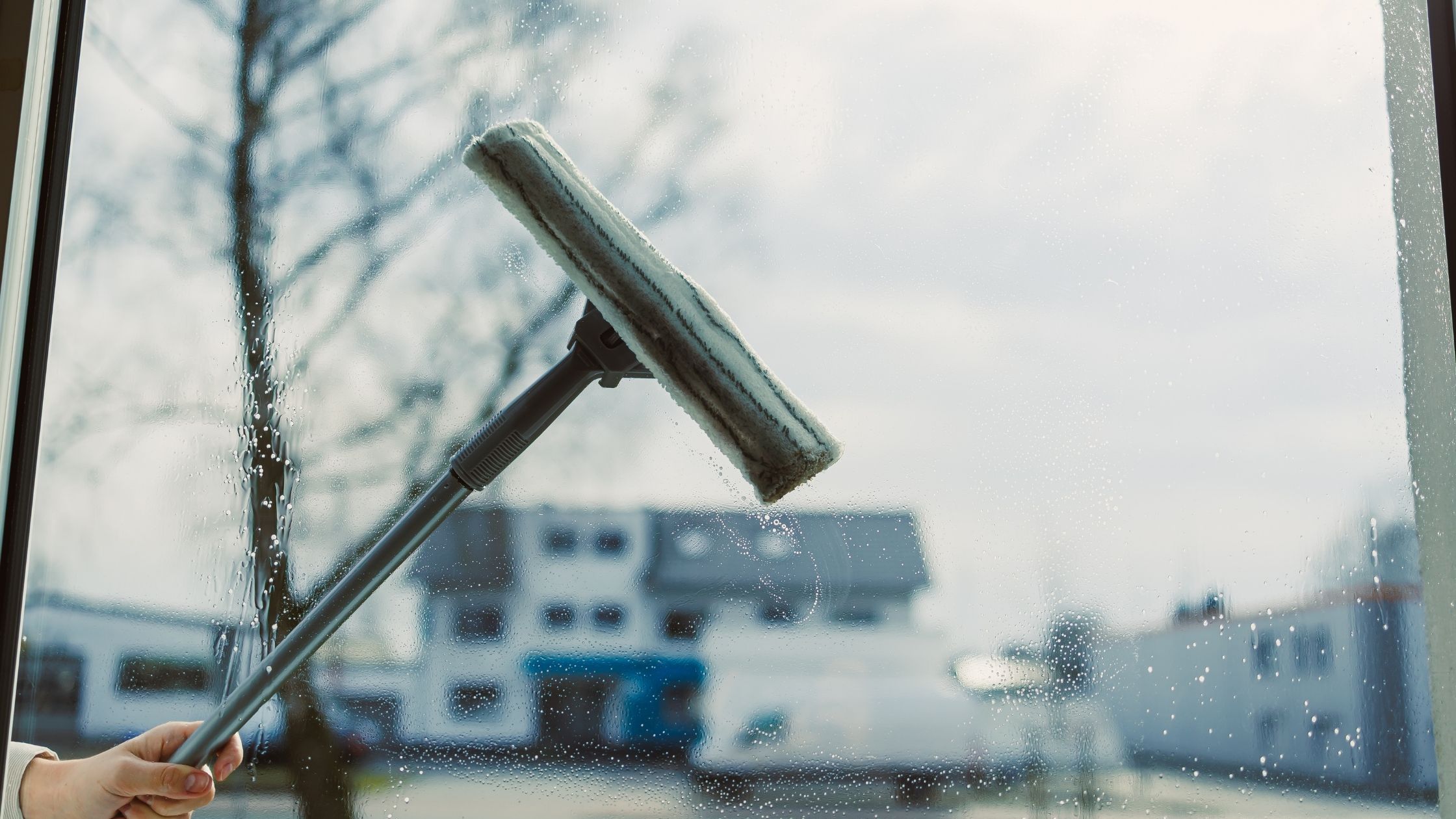 Someone cleaning a commercial window